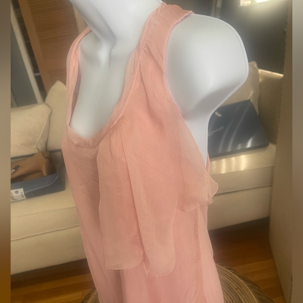 Orange top with ruffle on right side under arm size medium